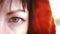 Gaze of Mystery: Close-Up of Woman's Eye in Hood Staring into the Camera