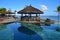 Gazebo bar next to a pool at tropical beach of a hotel resort