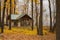 Gazebo in beautiful autumn forest surrounded by yellow leaves