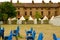 Gazebo in the castle park. Brick barracks built for defensive purposes by the Savoy. Stacked blue chairs in the park