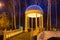 Gazebo with electric garlands in city park at winter