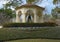 Gazebo, flower bed, bushes and trees in Flippen Park in Highland Park in Dallas, Texas