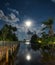 Gazebo and moon in waters reflection