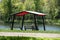 Gazebo in a park on the lake shore and a resting person from the back.