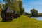 Gazebo pond shore line spring day time nature landscape clear weather day time green grass and foliage