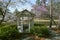 Gazebo by a pond surrounded by flowering trees