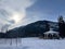 a gazebo that sits in the snow on a mountain