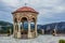 Gazebo stone European medieval building object in observation yard space with highland mountain background landscape in gray