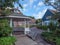 Gazebo surrounded by lush trees and cozy houses under a bright sky on Spiekeroog, Germany