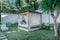 Gazebo with a wooden bed under a mosquito grid on a outside