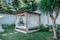 Gazebo with a wooden bed under a mosquito grid on a outside