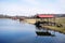 gazebos with a red roof on the shore of a spring lake