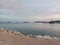 Gazing from the beach, islands dot the horizon, while a lone ship rests in the embrace of the local marine