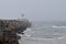 Gazing out to sea along the breakwater on a grey, stormy morning