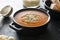 Gazpacho soup inblack bowl, delicious cold tomato soup. Dark background