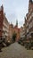 Gdansk - A deserted street in Old Town of Gdansk, Poland. The both sides of a paved alley have tall medieval buildings