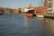 Gdansk, North Poland - August 13, 2020: A ship docked at shipyard, people enjoying kayak in motlawa river during covid era
