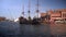 Gdansk, North Poland : People doing leisure activities and black pirate ship sailing in motlawa river over a