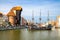 Gdansk, Poland, April 15, 2018: Medieval wooden ship on Motlawa river water, typical colorful houses buildings