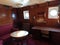Gdansk, Poland : Cabin with congested sitting area, vintage telephone with round window inside the SS Soldek ship,