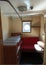 Gdansk, Poland: Cabin with congested sitting and sleeping area with round window inside the SS Soldek ship, part of