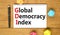 GDI global democracy index symbol. Concept words GDI global democracy index on white note on beautiful wooden table wooden