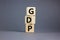 GDP, good distribution practice symbol. Concept words `GDP, good distribution practice` on cubes on a beautiful grey background.