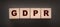 GDPR Word Written In Wooden Cubes on black