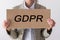 GDPR. A young woman is hidden behind the inscription General Data Protection Regulation.