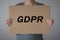 GDPR. A young woman is hidden behind the inscription General Data Protection Regulation.