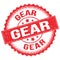 GEAR text on red round stamp sign