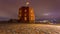 Gediminas castle in Vilnius, Lithuania, castle in evening light with city lights, tilting slider timelapse