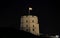 Gediminas Tower in Vilnius at night against a dark black sky