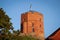 Gediminas' Tower in Vilnius, the remaining part of the Upper Castle, Lithuania with lithuanian flag on blue sky with