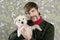 Geek retro man holding dog silly on wallpaper