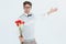 Geeky hipster offering bunch of roses