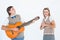 Geeky hipster serenading his girlfriend with guitar