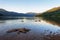 Geese swim close to shore on mountain lake