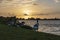 The geese walk to the water of lake Zoetermeerse plas during the setting sun