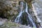 The Gega waterfall. Tourists at the foot of the largest waterfall in Abkhazia on a sunny summer day