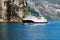 Geiranger, Geirangerfjord, Norway - June , 2019: Touristic ship berry boat floating liner near Geiranger in Geirangerfjorden in