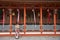 Geishas girl wearing Japanese kimono among red wooden Tori Gate at Fushimi Inari Shrine in Kyoto