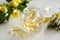 Gel capsules of evening primrose oil in a bottle with fresh flowers