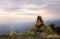 Gelada monkey sitting on an edge of a cliff at sunset