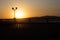 Gelendzhik embankment at sunset. Balustrade against the background of the sun at sunset. Bright red, red-black sunset