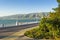 Gelendzhik paved promenade with greenery, lanterns, a balustrade and a bicycle lane. Sunny day during vacation at velvet