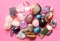 Gems of various colors. Amethyst, rose quartz, agate, apatite, aventurine, olivine, turquoise, aquamarine, rock crystal on pink