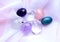 Gemstone minerals on a pink background. Round tumbling minerals of amethyst, rose quartz, rock crystal and apatite on white