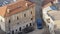 A gendarme patrol car with flashing beacons on stands in the old city quarter. Near the stone buildings with tiled roofs