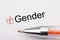 Gender - checkbox with a tick on white paper with metal pen. Checklist concept